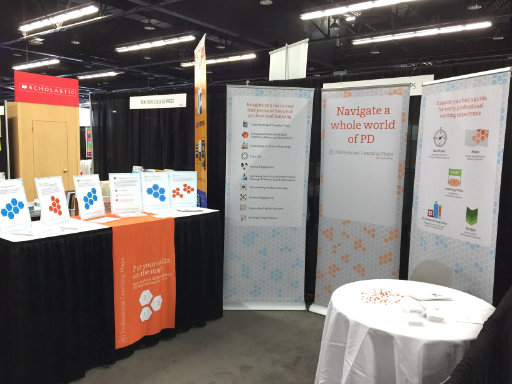 Photo of conference booth showing hanging banners and printed material for educators to learn about Professional Learning Maps